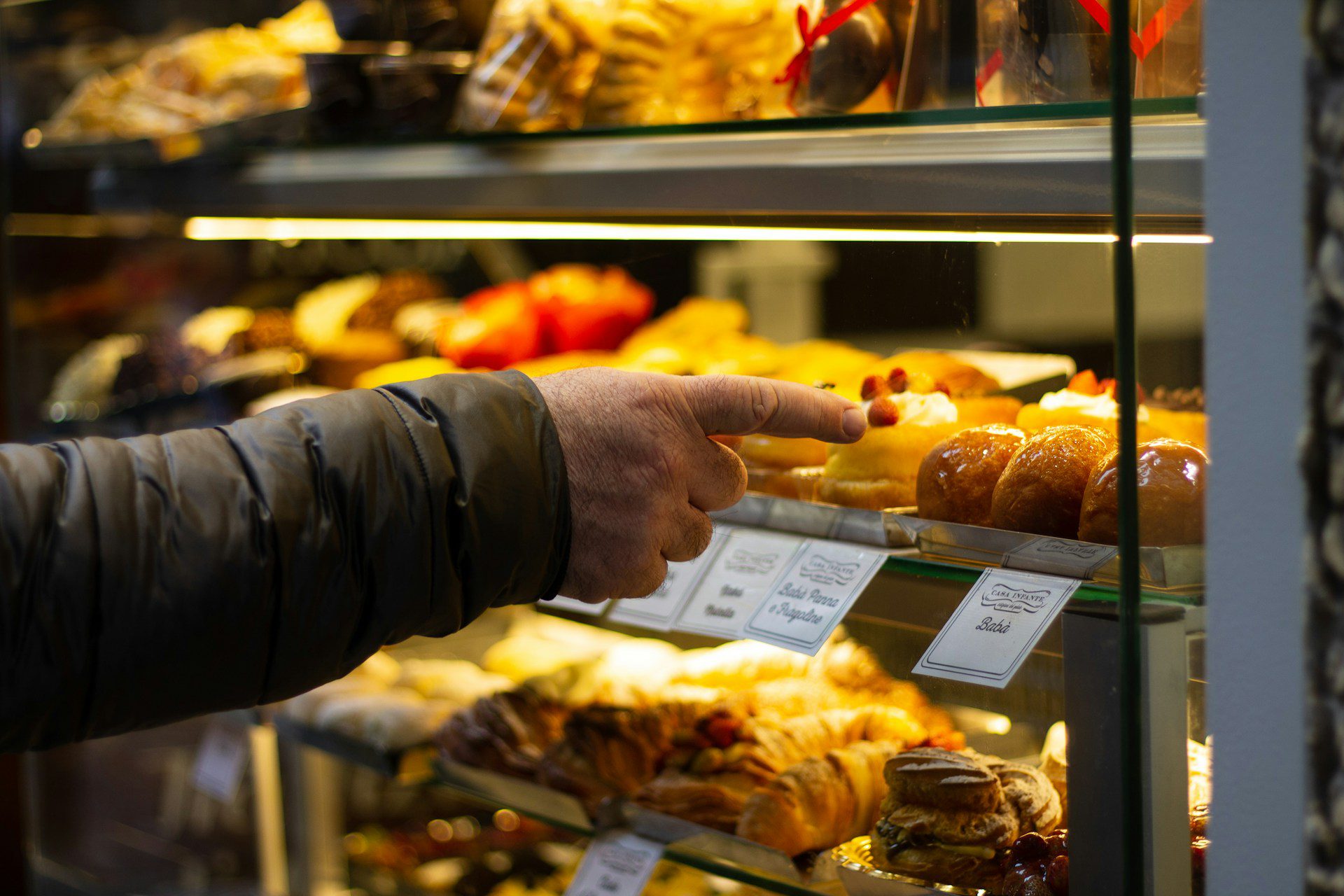 Image shows hand pointing at pastries, illustrating the idea of looking for a good resume writer.